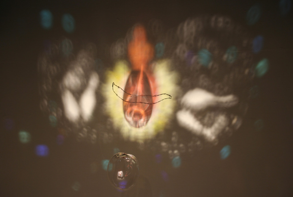 Blown glass, barbed wire, glass fragments on mirror