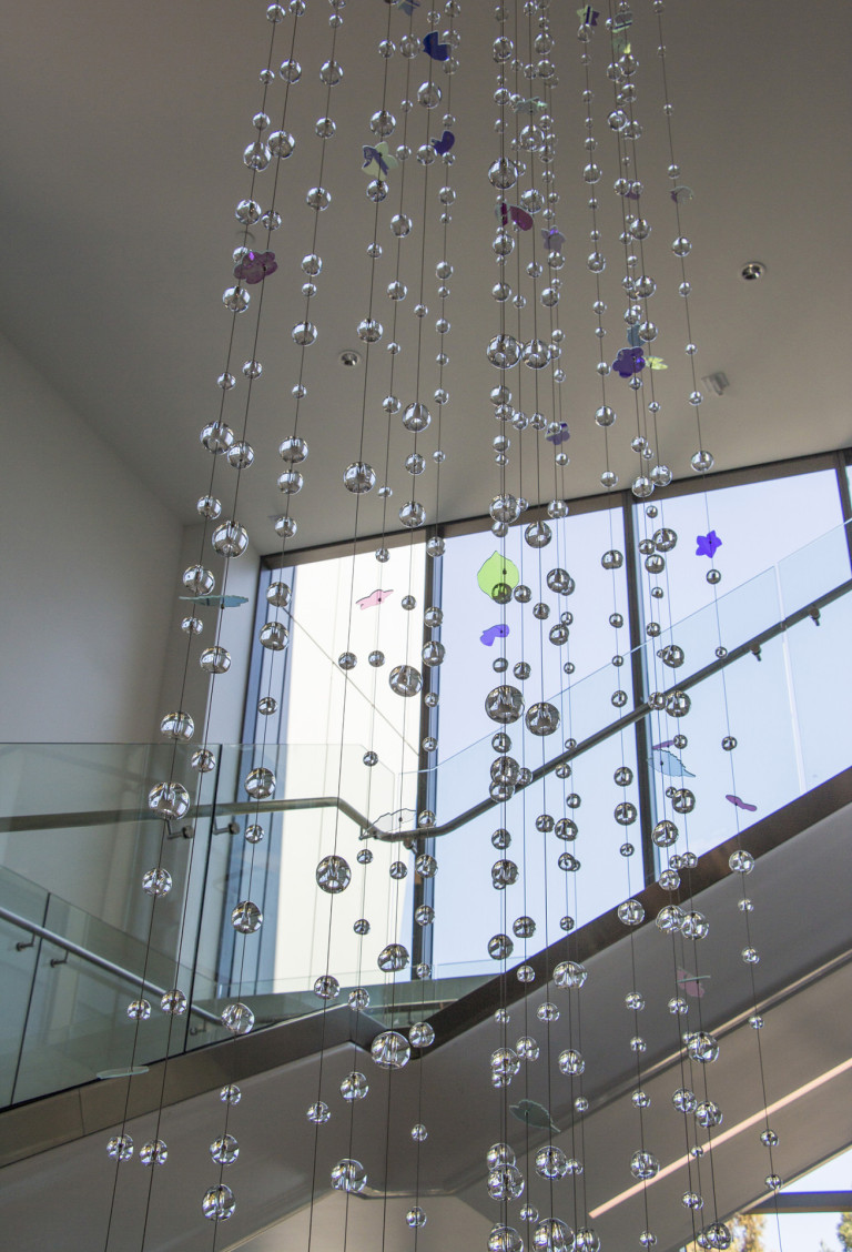 Hand-sculpted glass and dichroic glass suspended on stainless steel cables