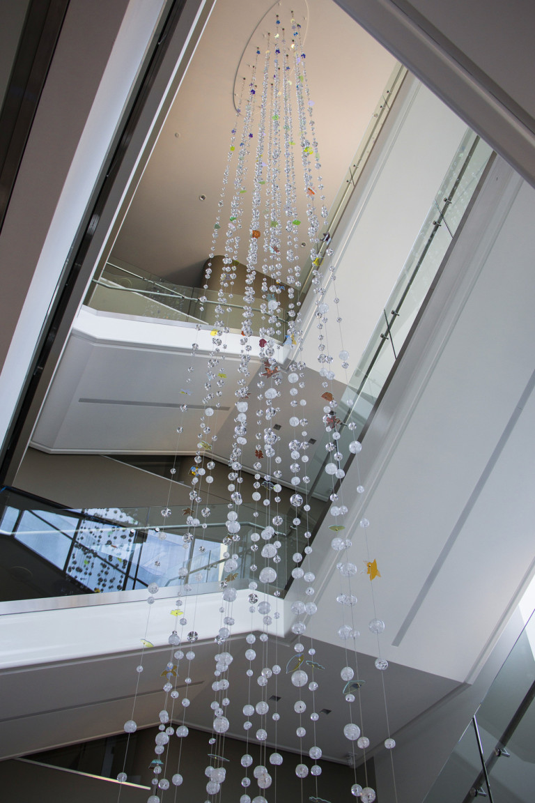 Hand-sculpted glass and dichroic glass suspended on stainless steel cables