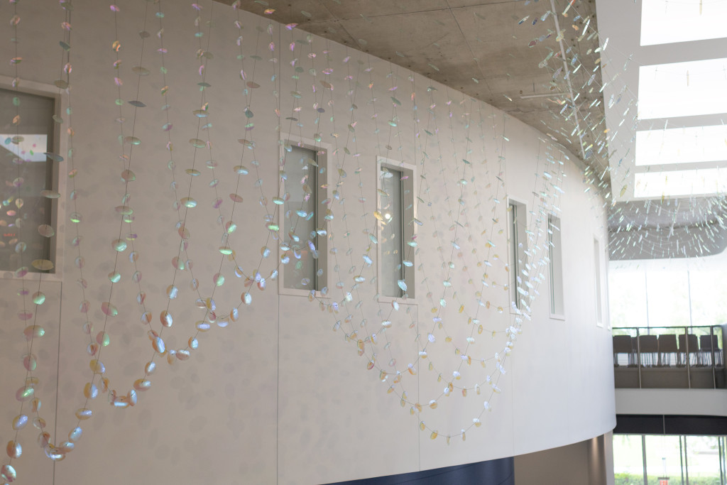 2,000 dichroic glass petals and leaves suspended in the a