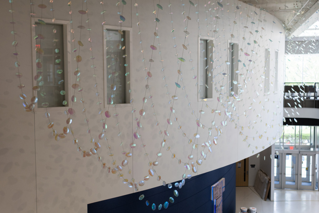 2,000 slumped dichroic glass petals and leaves suspended in the a