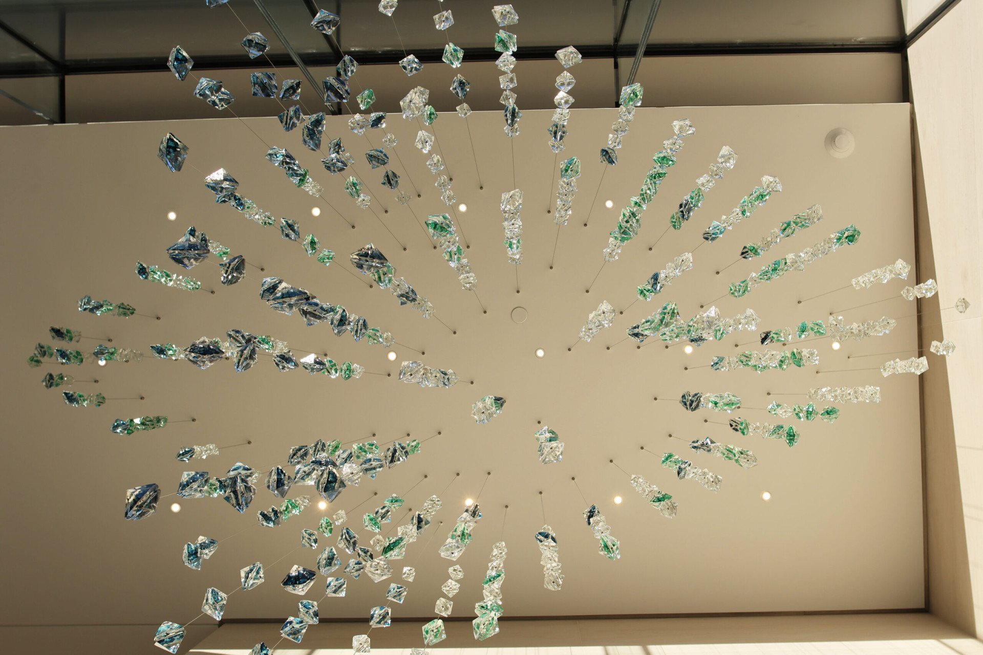 view from right below of the glass suspended sculpture in the morning