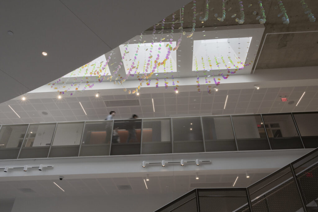 Looking up from the ground floor to the skylight. The colorful Glass suspended sculpture with 2,000 dichroic glass flower petals and leaves is visible inside Steven Wymer Hall, University of Illinois Urbana-Champaign