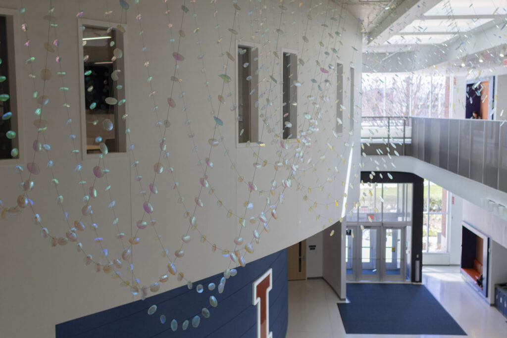 View from top of the grand stairway, Glass suspended sculpture with 2,000 dichroic glass flower petals and leaves inside Steven Wymer Hall, University of Illinois Urbana-Champaign
