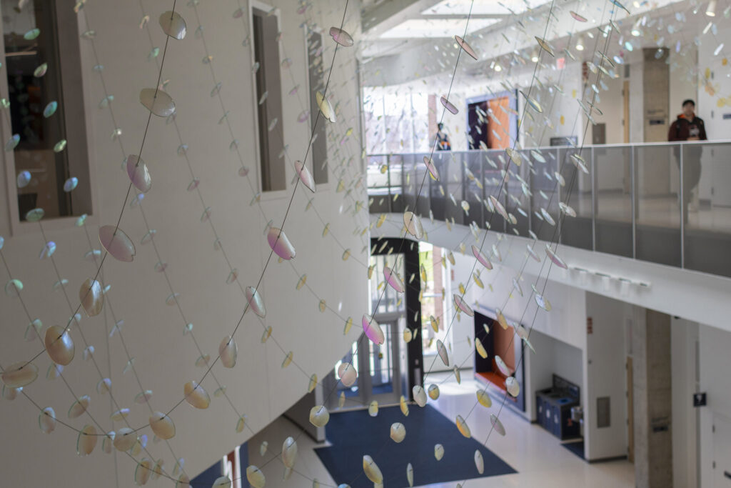 Detail of suspended dichroic glass petals in large-scale installation at University of Illinois Urbana-Champaign