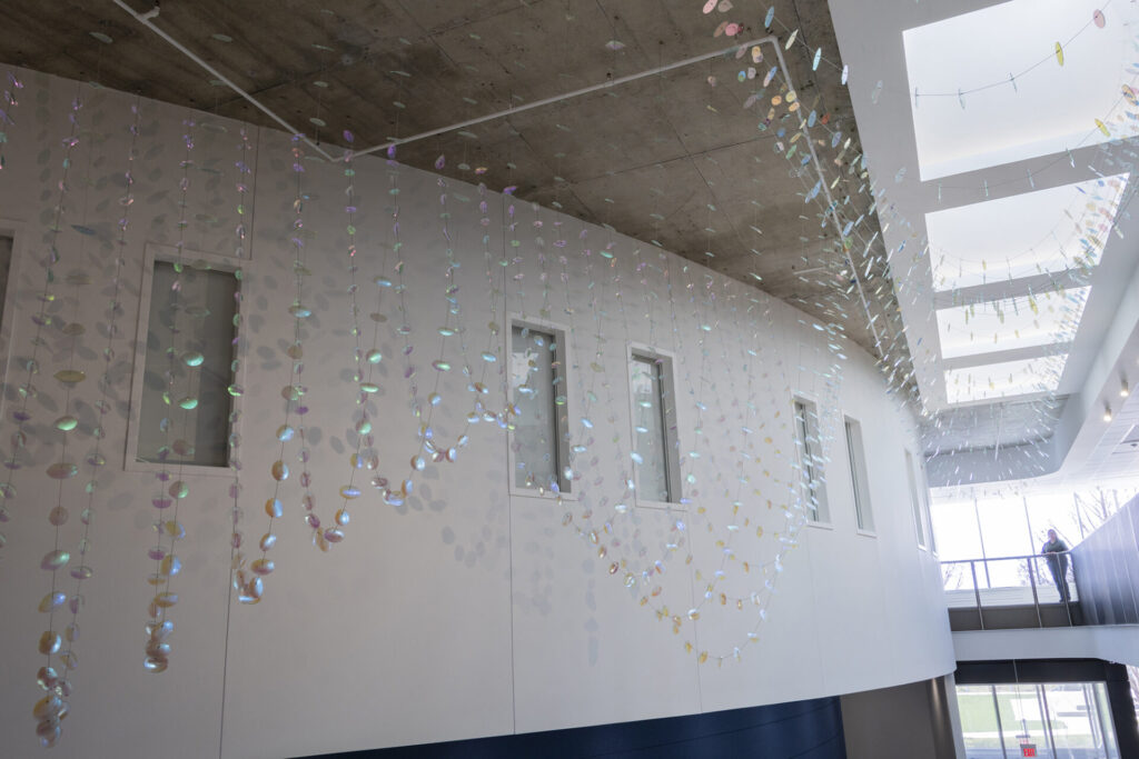 In the morning, Glass suspended sculpture with 2,000 dichroic glass flower petals and leaves inside Steven Wymer Hall, University of Illinois Urbana-Champaign