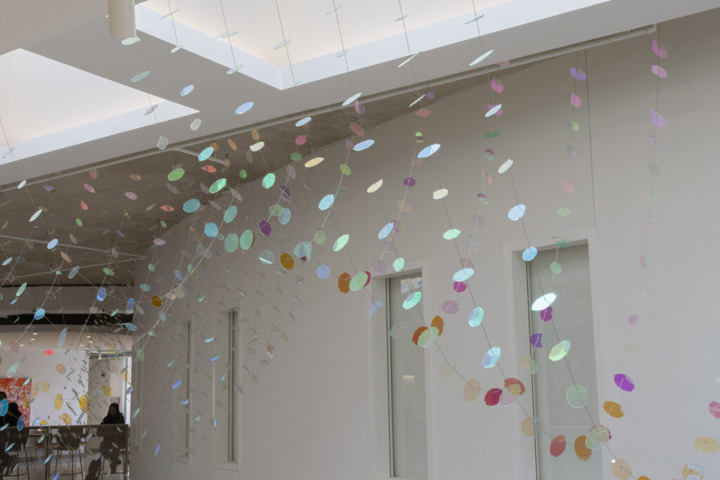 Detail view of Glass suspended sculpture with 2,000 dichroic glass flower petals and leaves inside Steven Wymer Hall, University of Illinois Urbana-Champaign
