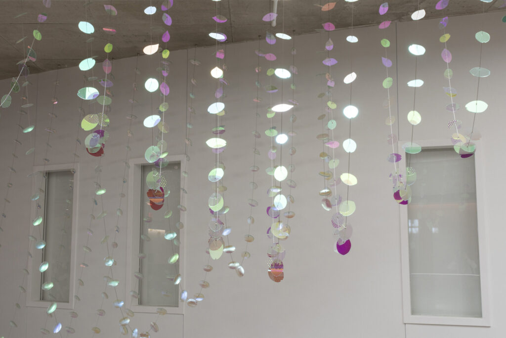 Detail view of Glass suspended sculpture with 2,000 dichroic glass flower petals and leaves inside Steven Wymer Hall, University of Illinois Urbana-Champaign