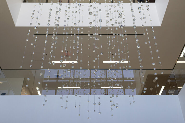 Waterfall: Ice to Clarity, suspended glass installation by Kana Tanaka at Enloe Health Gonzales Comprehensive Cancer Center in Chico, California